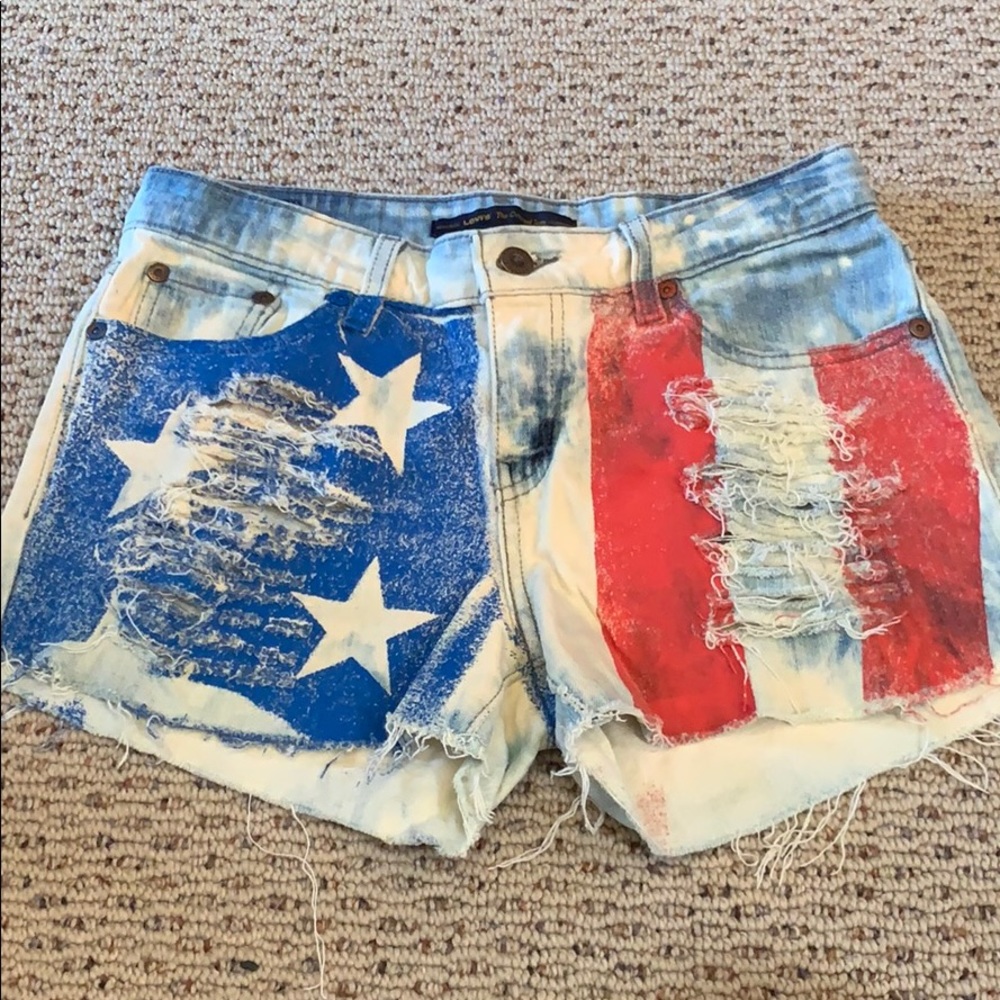 mid rise distressed american flag denim shorts.